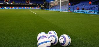 Footballs on pitch