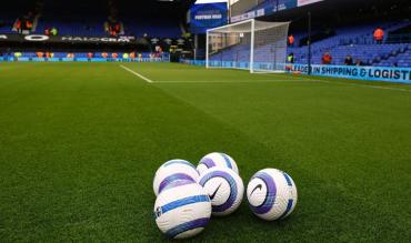 Footballs on pitch